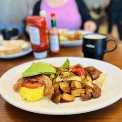 Casa de Nati - Bacon Avocado Omelette with a side of crispy potatoes with bell peppers and onions