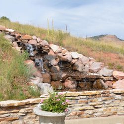 Four Elements Landscape & Outdoor Living - Designing a water feature thatblen into the hillside like it's part of nature