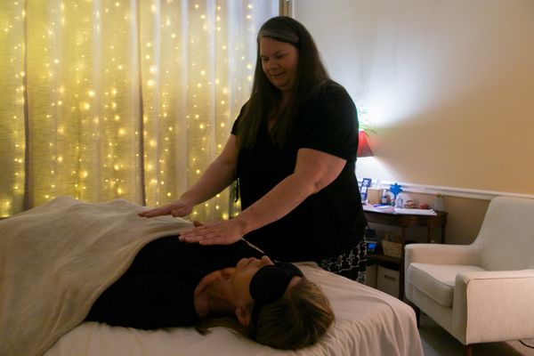 New Client Reiki Session - New Client Reiki sessions include more extensive conversation to gather background information and discuss goals, a 40-minute Reiki treatment, energy clearing, and aftercare instructions. Plan for 1.5 hours for this session.
Think you may want to give Reiki healing a try but not sure? Visit my website for more information about this healing technique or read below for more information. The full article can be found under the blog tab on my website.
Reiki (pronounced ray-key) is an ancient Japanese energy healing technique that promotes stress reduction, emotional release, physical healing, and inner peace. The word Reiki combines Rei (universal) and Ki (life force energy). This healing practice helps clear energetic blockages so your body and mind can return to a more balanced state.
Reiki is performed by a certified practitioner who gently places their hands either just above or lightly on your body. You remain fully clothed and usually will be lying down comfortably on a massage table; however, it can be done while sitting in a chair. The practitioner channels healing energy through their hands into your body, targeting areas that may feel blocked, heavy, or out of sync. The session usually begins with your head, neck, and shoulders and then moves down your body, ending with the practitioner helping to ground you by applying the healing energy to your ankles and feet. You can let go of the outcome, trusting that your body knows what to do with the healing energy. New Client Reiki Session - New Client Reiki sessions include more extensive conversation to gather background information and discuss goals, a 40-minute Reiki treatment, energy clearing, and aftercare instructions. Plan for 1.5 hours for this session.
Think you may want to give Reiki healing a try but not sure? Visit my website for more information about this healing technique or read below for more information. The full article can be found under the blog tab on my website.
Reiki (pronounced ray-key) is an ancient Japanese energy healing technique that promotes stress reduction, emotional release, physical healing, and inner peace. The word Reiki combines Rei (universal) and Ki (life force energy). This healing practice helps clear energetic blockages so your body and mind can return to a more balanced state.
Reiki is performed by a certified practitioner who gently places their hands either just above or lightly on your body. You remain fully clothed and usually will be lying down comfortably on a massage table; however, it can be done while sitting in a chair. The practitioner channels healing energy through their hands into your body, targeting areas that may feel blocked, heavy, or out of sync. The session usually begins with your head, neck, and shoulders and then moves down your body, ending with the practitioner helping to ground you by applying the healing energy to your ankles and feet. You can let go of the outcome, trusting that your body knows what to do with the healing energy.