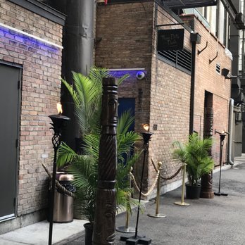 Three Dots and A Dash - Alley grand entrance. There is a bouncer at door not checking IDs so I'm sure just to keep it safe when it gets dark out. - Asian Fusion Near Me - Chicago, Illinois Three Dots and A Dash - Alley grand entrance. There is a bouncer at door not checking IDs so I'm sure just to keep it safe when it gets dark out. - Asian Fusion Near Me - Chicago, Illinois