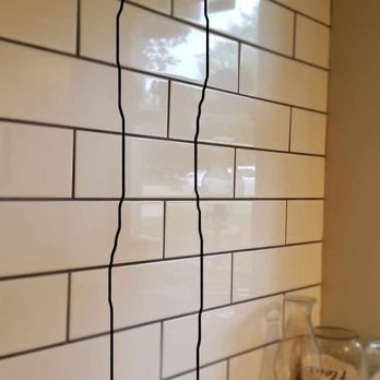 Kings Remodel - crack from countertop to ceiling on tiled foundation wall - General Contractors Near Me - Lee's Summit, Missouri
