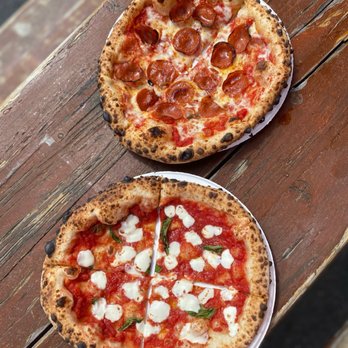 Uptown Pizza WS - two pizzas on a table - Food Trucks Near Me Uptown Pizza WS - two pizzas on a table - Food Trucks Near Me