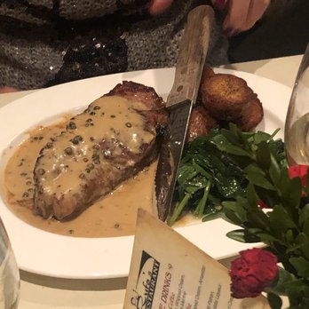 Mesa 46 - a person cutting a steak with a knife - Italian Near Me - Woodland Park, New Jersey Mesa 46 - a person cutting a steak with a knife - Italian Near Me - Woodland Park, New Jersey