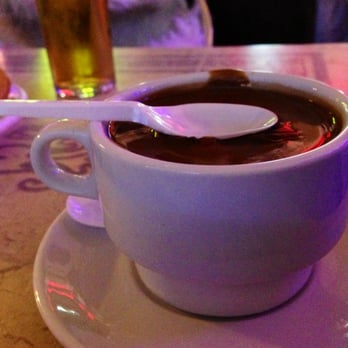 Maestro Churrero - Suspended spoon on hot chocolate - Churros Near Me - Madrid, M