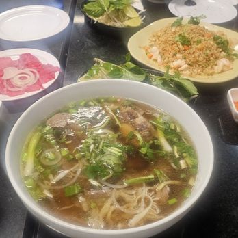 Pho Saigon - Pho ox tail with the meat on the side with raw onions, freshly cut Thai chili peppers, complementary hot tea, and shrimp fried rice - Vietnamese Near Me - Kent, Washington Pho Saigon - Pho ox tail with the meat on the side with raw onions, freshly cut Thai chili peppers, complementary hot tea, and shrimp fried rice - Vietnamese Near Me - Kent, Washington