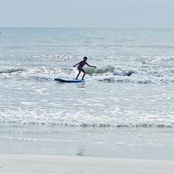 Nex Generation Surf School - 8 year old catching her very first wave & on her first try!