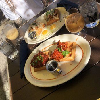 Tupelo Honey Southern Kitchen & Bar - Sriracha honey chicken and i forget what he had it was eggs and chicken had gravy on them - Southern Near Me - Denver, Colorado Tupelo Honey Southern Kitchen & Bar - Sriracha honey chicken and i forget what he had it was eggs and chicken had gravy on them - Southern Near Me - Denver, Colorado