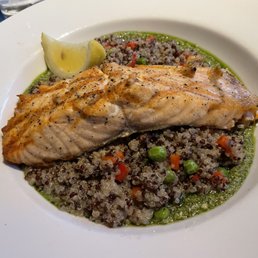 Salmon entrée on a bed of quinoa and pesto. Salmon entrée on a bed of quinoa and pesto.
