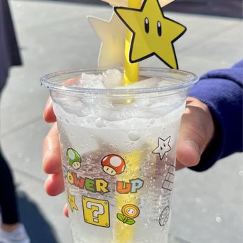 Power Up Cafe - Super Star Fizz - Lemon lime soda w/ lemon popping pearls and a mango pineapple Super Star Power Up! - Themed Cafes Near Me - Universal City, California