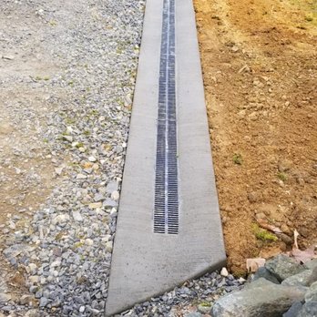 Dave’s Landscaping - a concrete walkway in the middle of a field - Landscaping Near Me Dave’s Landscaping - a concrete walkway in the middle of a field - Landscaping Near Me