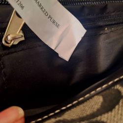 Armory Auction House - The designer mark is a leather label that should be below the zipper, on the inside pocket.