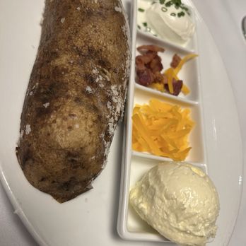 1832 Steakhouse - Half of a baked potato! It was huge! - Steakhouses Near Me - Durant, Oklahoma