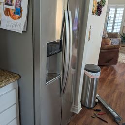 Old wall sticks out by fridge.