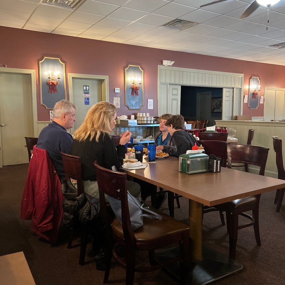 a group of people sitting at a table a group of people sitting at a table