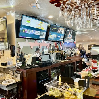The Eagle’s Nest Restaurant - a bar with wine glasses hanging from the ceiling - Barbeque Near Me - Bokeelia, Florida