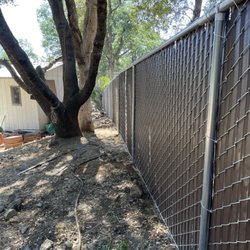 Alderson Fencing - 6ft Brown Vinyl slats in Chainlink fence in backyard