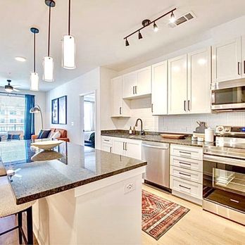 Taryn At 401 - Well-appointed bright kitchen, featuring sleek appliances, including an induction cooktop. - Apartments Near Me - Raleigh, North Carolina