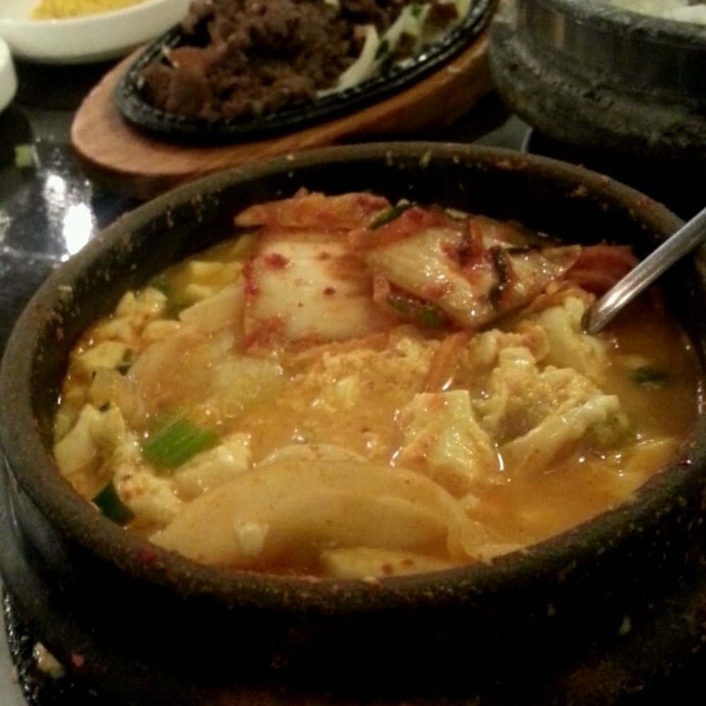 Soy Tofu - Kimchi Dumpling Tofu Soup. Bulgogi and side dishes chillin in the background. - Korean Near Me - La Palma, California Soy Tofu - Kimchi Dumpling Tofu Soup. Bulgogi and side dishes chillin in the background. - Korean Near Me - La Palma, California