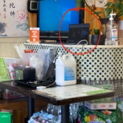 Amitabha Vegan Restaurant - Computer screen person running the take-out booth