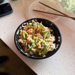 All About Poke - Half way eaten salmon bowl with edamame, cucumber, pineapple, green onions. Put the honey and miso mayo!! So good!