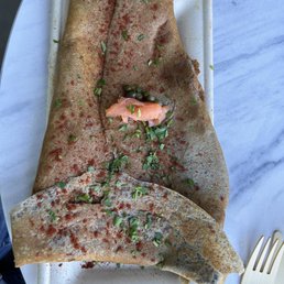 Galette with salmon, goat cheese, egg, confit onions, and caper
