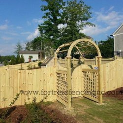 Fortress Fencing - Arch stockade privacy fence with custom arbor and walk gate installed by Fortress Fencing LLC