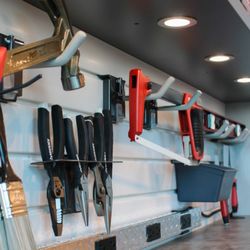 Inspired Closets Hawaii - Custom slatwall garage unit. Organizing tools above the workbench. Utilizing slatwall and accessories.