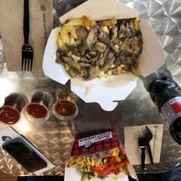 a plate of fries and a bottle of beer