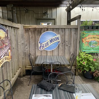 L'italia - a woman taking a picture of a patio - Italian Near Me - Wellsville, New York