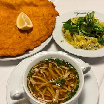 Figlmüller - Schnitzel, potato salad, clear beef broth with sliced pancakes. - Austrian Near Me - Vienna, 9 Figlmüller - Schnitzel, potato salad, clear beef broth with sliced pancakes. - Austrian Near Me - Vienna, 9