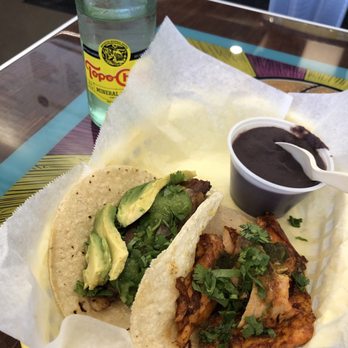 Tacodeli - Wednesday special : Delibelly and the salmon taco, side of beans and Topo Chico. - Tacos Near Me - Dallas, Texas