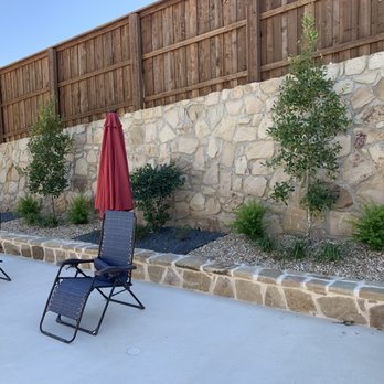 Spur Landscape - a patio with chairs and an umbrella - Masonry/Concrete Near Me Spur Landscape - a patio with chairs and an umbrella - Masonry/Concrete Near Me