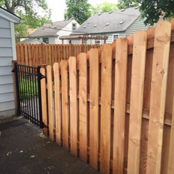 Boulevard Fence - Shadowbox style cedar privacy fence with ornamental iron gate.