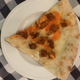 Pizza bread with a few pieces of chicken and a tiny bit of Buffalo sauce Pizza bread with a few pieces of chicken and a tiny bit of Buffalo sauce