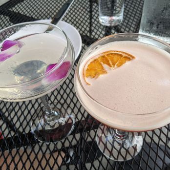 Pineapple Ink Tavern - mixed drinks in glasses sitting on wired outdoor table - Beer Bar Near Me - Augusta, Georgia Pineapple Ink Tavern - mixed drinks in glasses sitting on wired outdoor table - Beer Bar Near Me - Augusta, Georgia