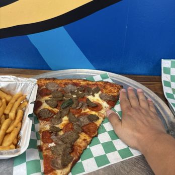 The Corner Crust Pizza And Brew - Size comparison between my hand, the pizza slice and the container of fries. - Pizza Near Me - Kannapolis, North Carolina The Corner Crust Pizza And Brew - Size comparison between my hand, the pizza slice and the container of fries. - Pizza Near Me - Kannapolis, North Carolina