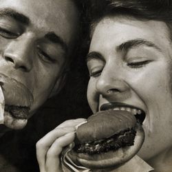 US Post Office - Two people eating hamburgers. Ain't nobody got time for hot dogs. Sheeit.