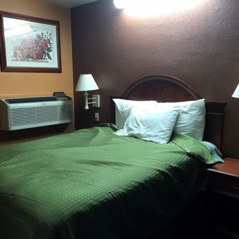 New Corral Motel - Things were neater when I first entered the room but I was too tired then. Full-sized bed, air conditioner/heater to the side - Hotels Near Me - Victorville, California