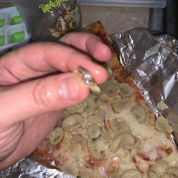 Two Brothers Pizza - a hand holding a slice of pizza - Pizza Near Me - Bronx, New York