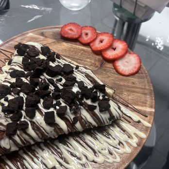 ChocoLit Cafe - Banana and strawberry stuffed crepe with Nutella and Belgian white chocolate drizzle topped with brownies. - Cafes Near Me - Roseville, California ChocoLit Cafe - Banana and strawberry stuffed crepe with Nutella and Belgian white chocolate drizzle topped with brownies. - Cafes Near Me - Roseville, California