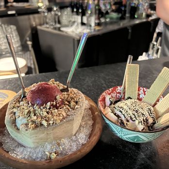 Moon Bar - Coconut rice pudding with hibiscus sorbet and almond crumble (left). Banana ice cream and dulce de leche wafers (right). - Tapas/Small Plates Near Me - Boston, Massachusetts Moon Bar - Coconut rice pudding with hibiscus sorbet and almond crumble (left). Banana ice cream and dulce de leche wafers (right). - Tapas/Small Plates Near Me - Boston, Massachusetts
