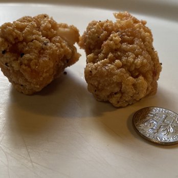 Wingstop - a quarter of a fried chicken nugget next to a quarter of a fried chicken nugget - Chicken Wings Near Me - Los Angeles, California
