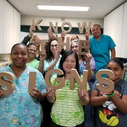 The staff bringing attention to Ovarian Cancer Awareness month.