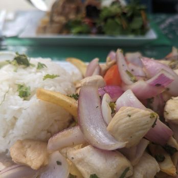 Lamas - Chicken Lomo Saltado in the foreground and Lechonada Peruana in the background - Mexican Near Me - Half Moon Bay, California Lamas - Chicken Lomo Saltado in the foreground and Lechonada Peruana in the background - Mexican Near Me - Half Moon Bay, California