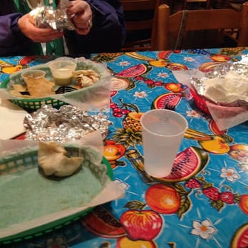 Blue Coast Burrito - a woman sitting at a table - Mexican Near Me - N. Little Rock, Arkansas