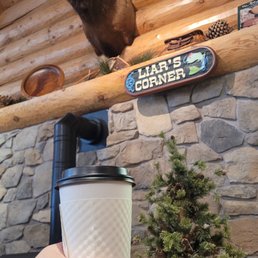 a hand holding a cup of coffee a hand holding a cup of coffee