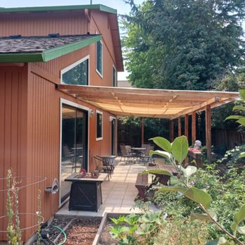 Kingdom Paint & Renovations - a patio with a pergolated roof - General Contractors Near Me