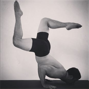 Tim Bish Wellness - Tim Bish doing a variation on the locust yoga pose. - Yoga Near Me Tim Bish Wellness - Tim Bish doing a variation on the locust yoga pose. - Yoga Near Me