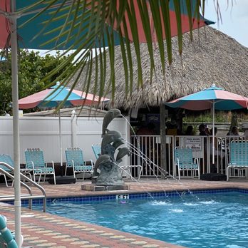 Plaza Beach Hotel - Beachfront Resort - Pool has dolphin theme. Really cute fountain and love the paver deck. There is a tiki bar for beverages. - Hotels Near Me - St. Pete Beach, Florida
