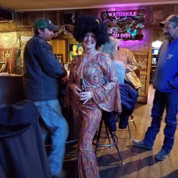 Waterhole Saloon - a woman in a disco outfit - Bars Near Me - Stanford, Montana
